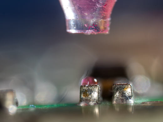 Figure 4: Nanolitre dosing on a circuit board. The drop is small enough to sit on a single component.